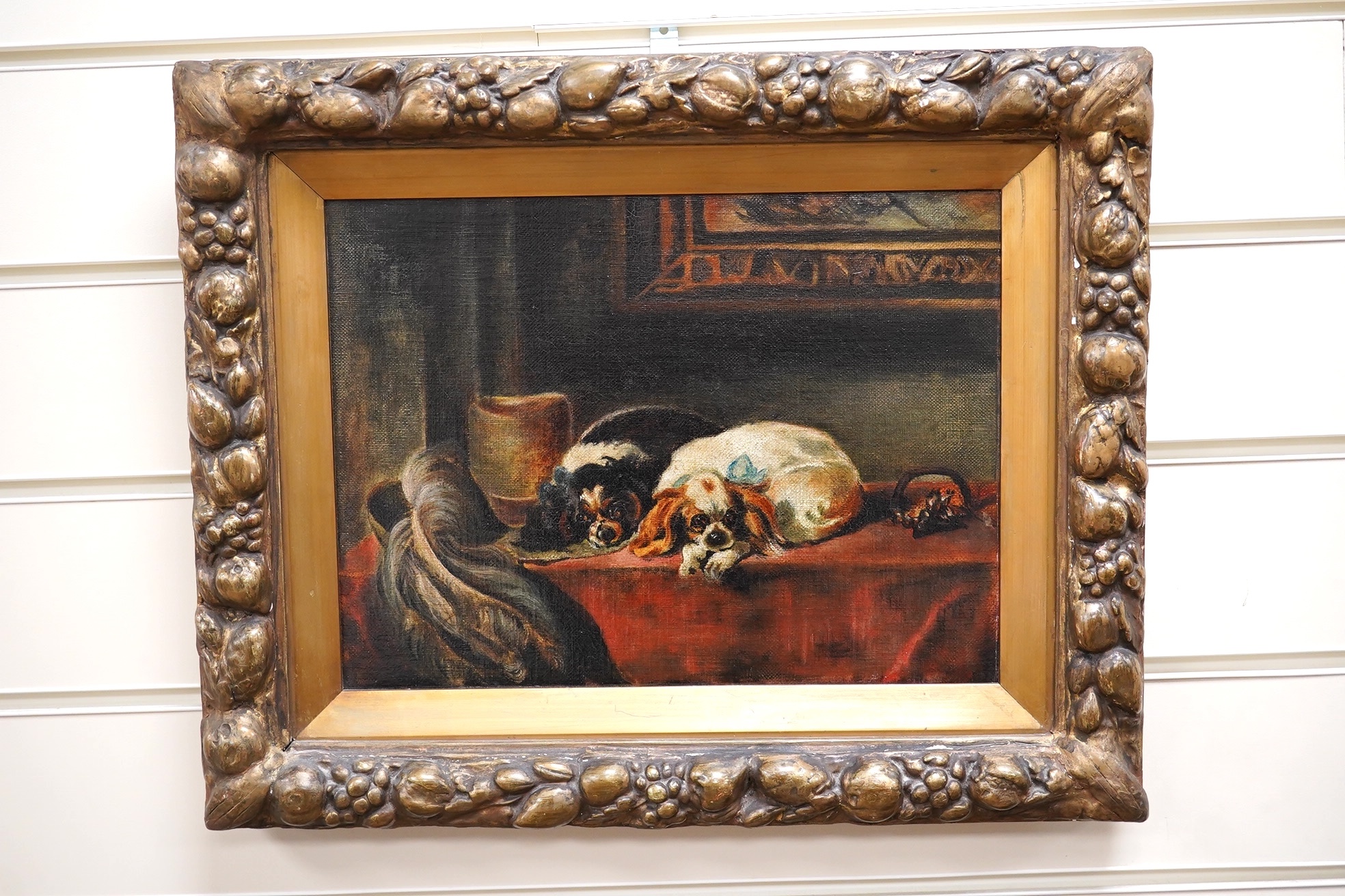 Early 20th century English School, oil on canvas, Study of two Cavalier King Charles spaniels in an interior, 21 x 29cm, gilt framed. Condition - fair to good, general craquelure throughout